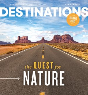 The cover of Destinations Magazine Summer 2022 Issue: The Quest for Nature showing a road and red rock formations.