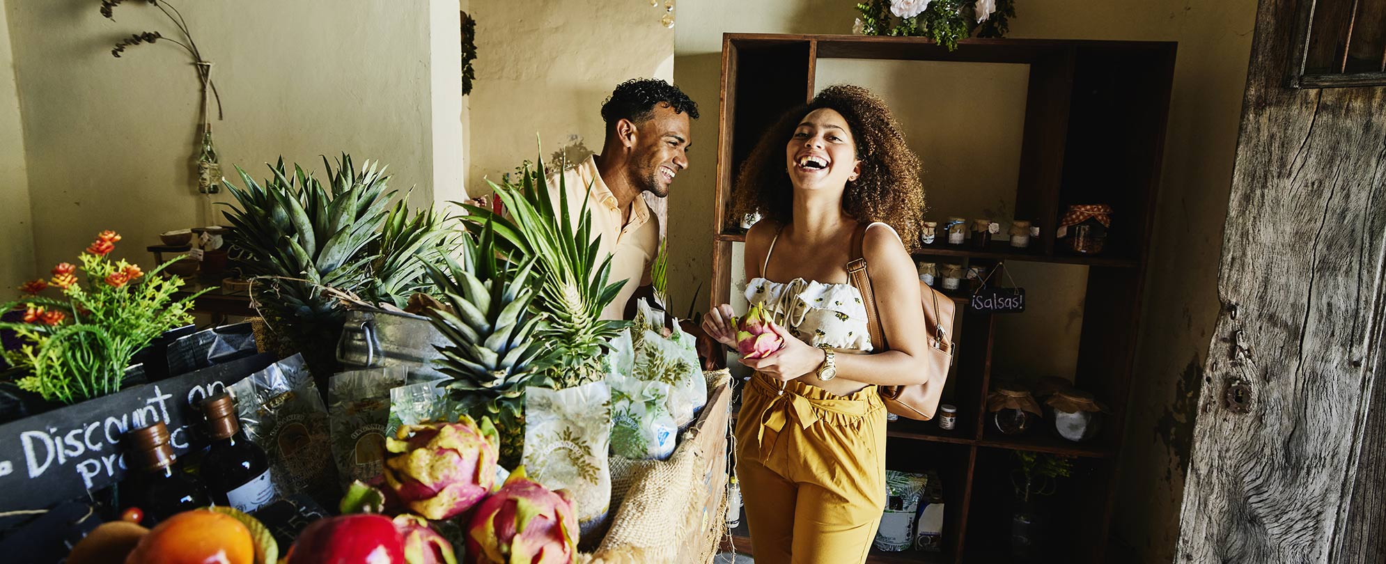Man and woman laughing in local plant shop.