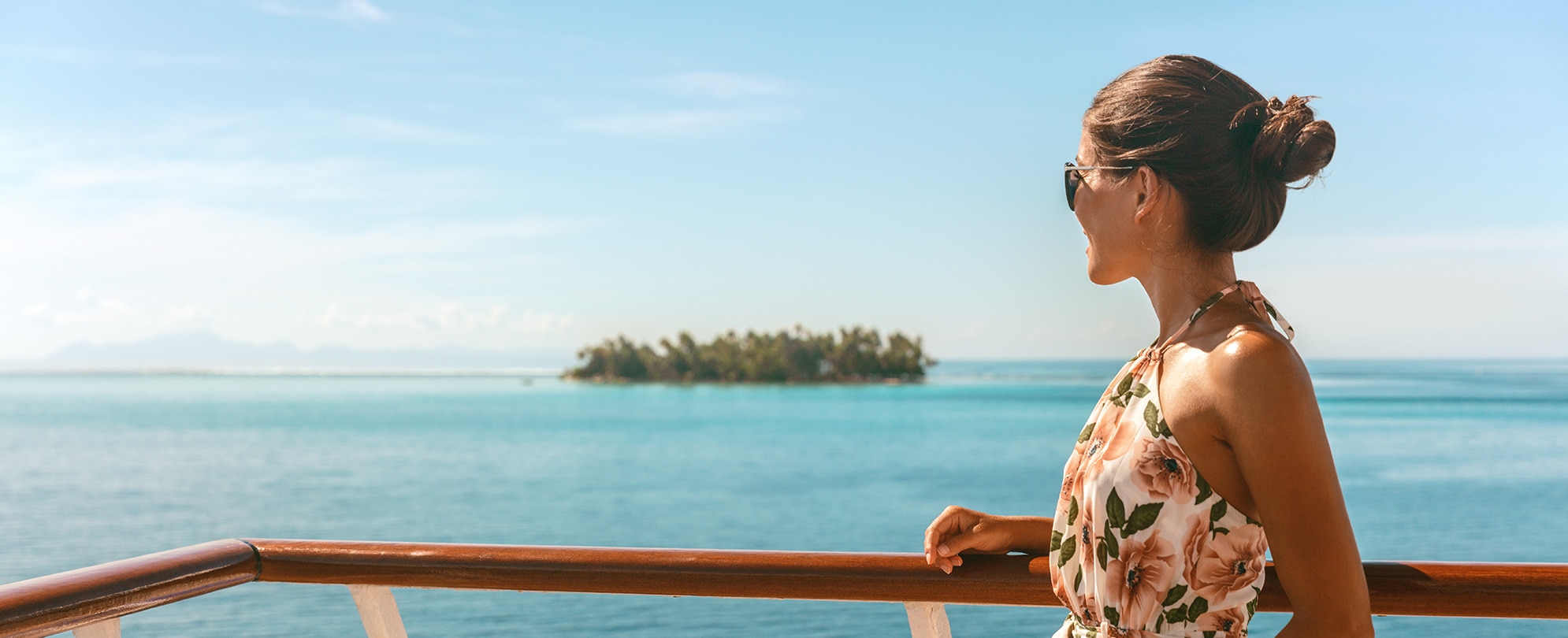 Cruise ship travel vacation luxury tourism woman looking at ocean from deck of sailing boat. Luxury Tahiti Bora Bora French Polynesia destination summer lifestyle.