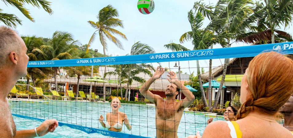 A family playing volleyball in a Margaritaville Vacation Club resort pool. 