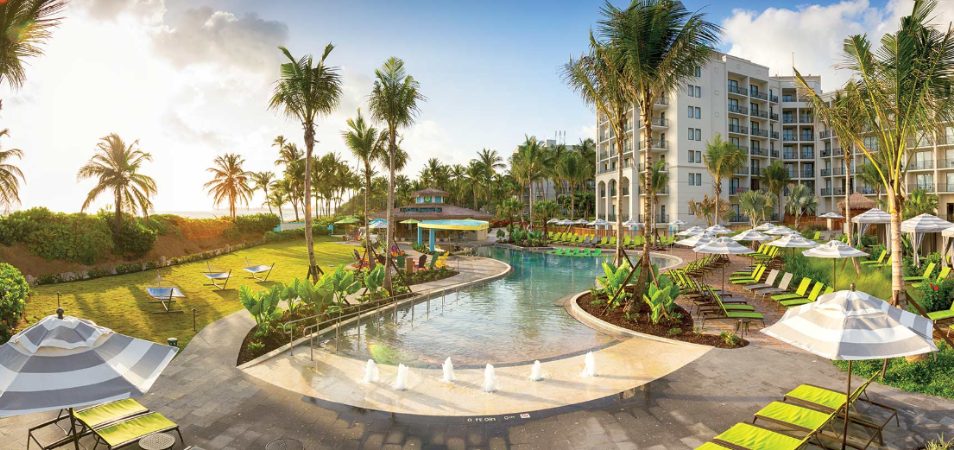 A zero-entry pool with fountains at Margaritaville Vacation Club by Wyndham - Rio Mar, an oceanfront timeshare resort.