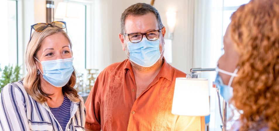 Man and woman wearing blue medical masks at a Margaritaville Vacation Club resort during the COVID-19 pandemic.