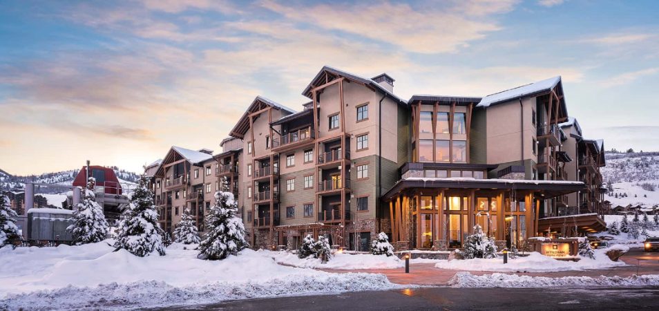 The exterior of Club Wyndham Park City, a timeshare resort, surrounded by snow during wintertime.