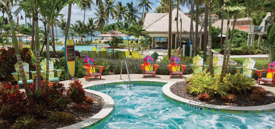 Colorful adirondack chairs surround a jetted hot tub at Margaritaville Vacation Club by Wyndham - St. Thomas.