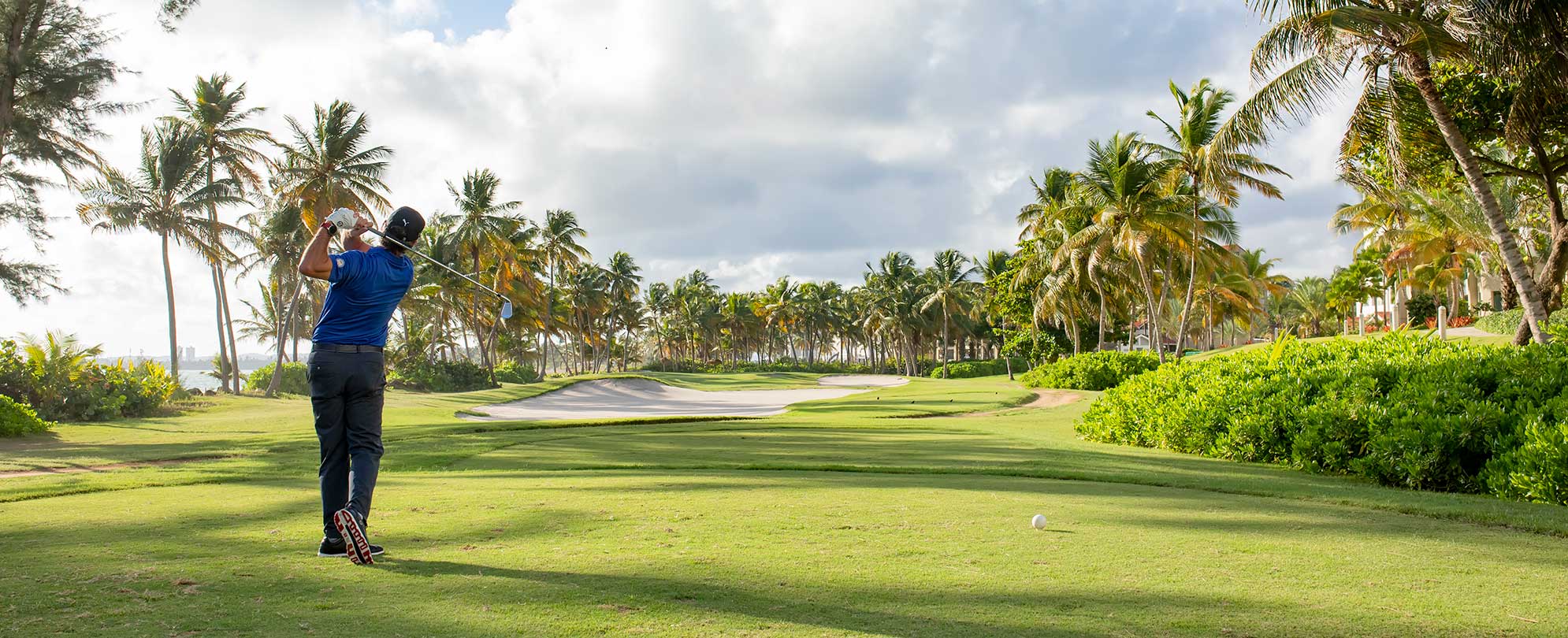 A man golfing at one of the popular Puerto Rico golf courses near Margaritaville Vacation Club by Wyndham - Rio Mar.