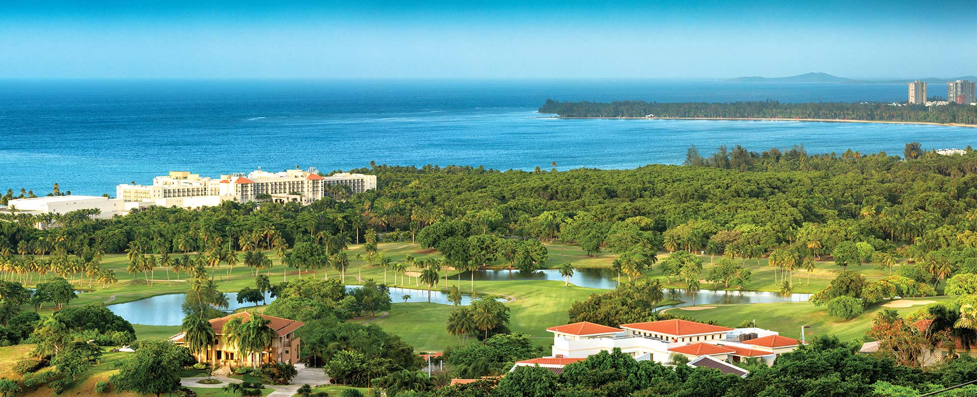 Birds-eye-view of golf course and ocean near Margaritaville Vacation Club by Wyndham - Rio Mar