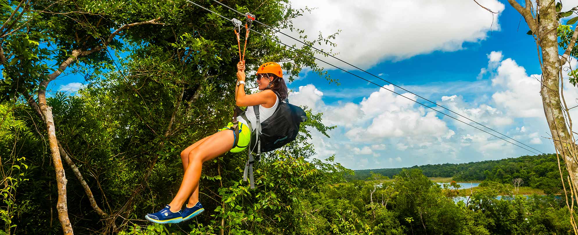 A woman ziplines through the trees at Toro Verde Adventure Park, a top thing to do in Puerto Rico.