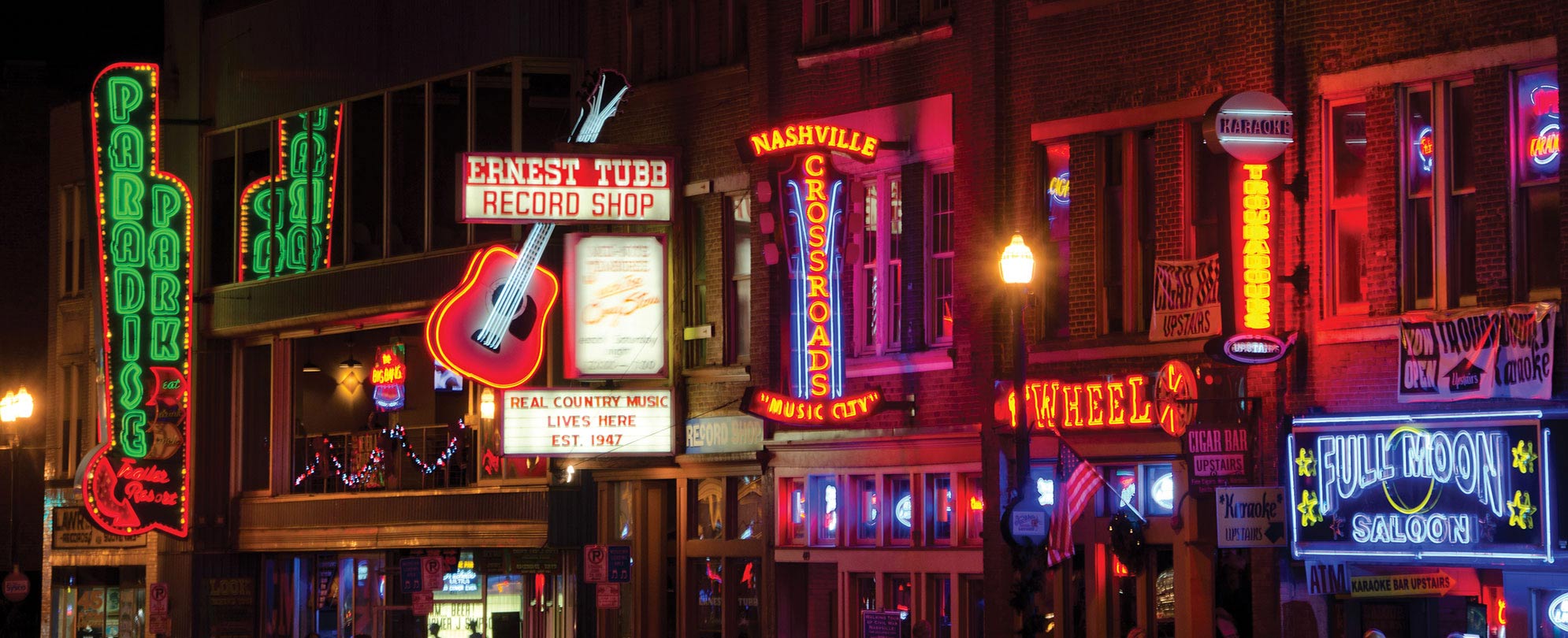 Bar signs lit up at night along Honky-Tonk Highway in Lower Broadway in Nashville, Tennessee