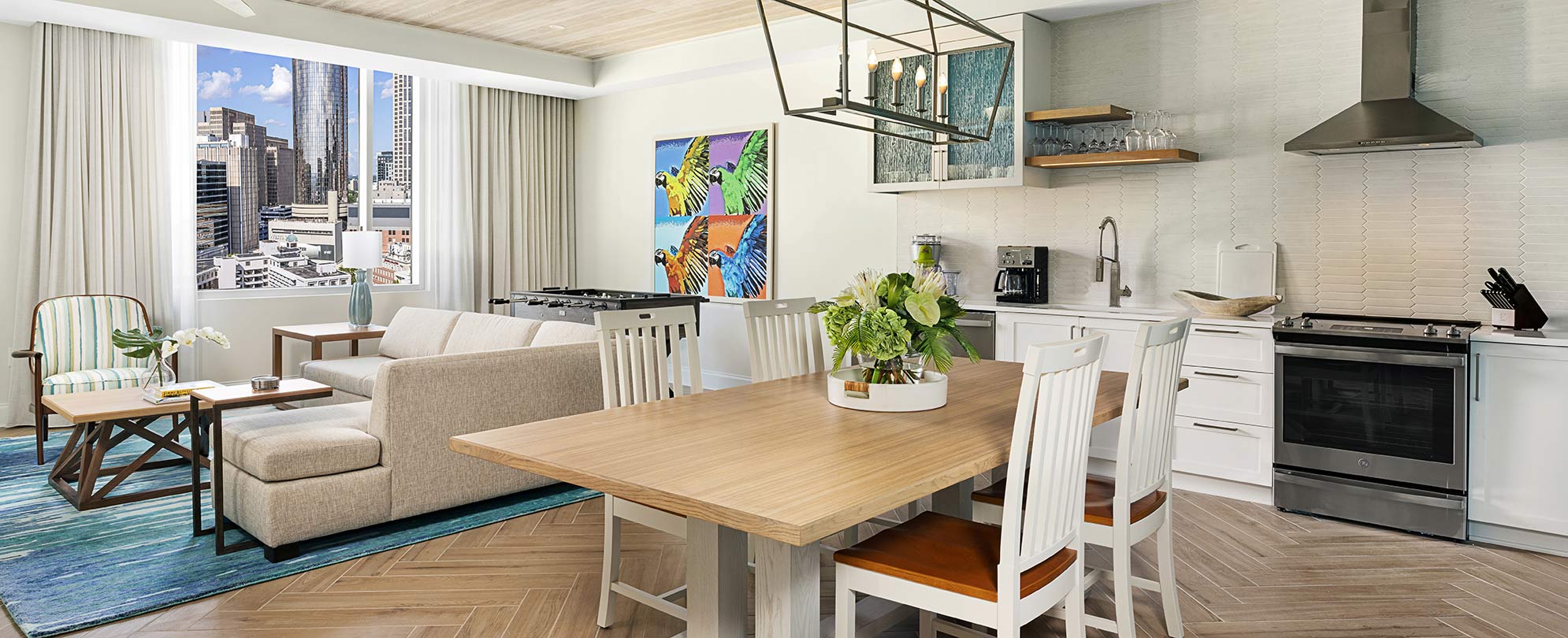 A modern decorated room with a sofa and small kitchen area at Margaritaville Vacation Club by Wyndham in Atlanta. 
