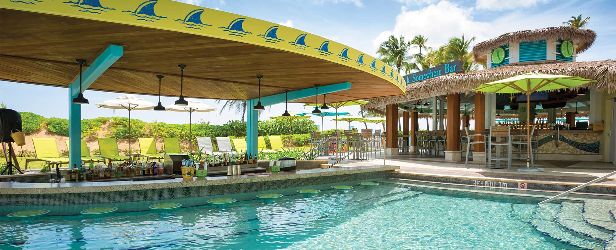 A swim-up bar with the Landshark logo at the pool of Margaritaville Vacation Club by Wyndham - Rio Mar.