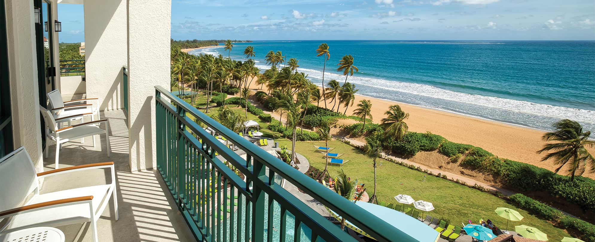 A view of the ocean and pool from a balcony at Margaritaville Vacation Club by Wyndham - Rio Mar, a timeshare resort.