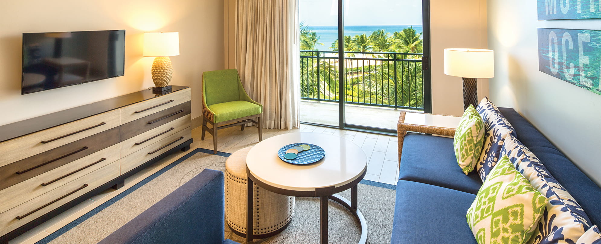 Suite living room with a sliding door to an oceanview balcony at Margaritaville Vacation Club by Wyndham - Rio Mar.