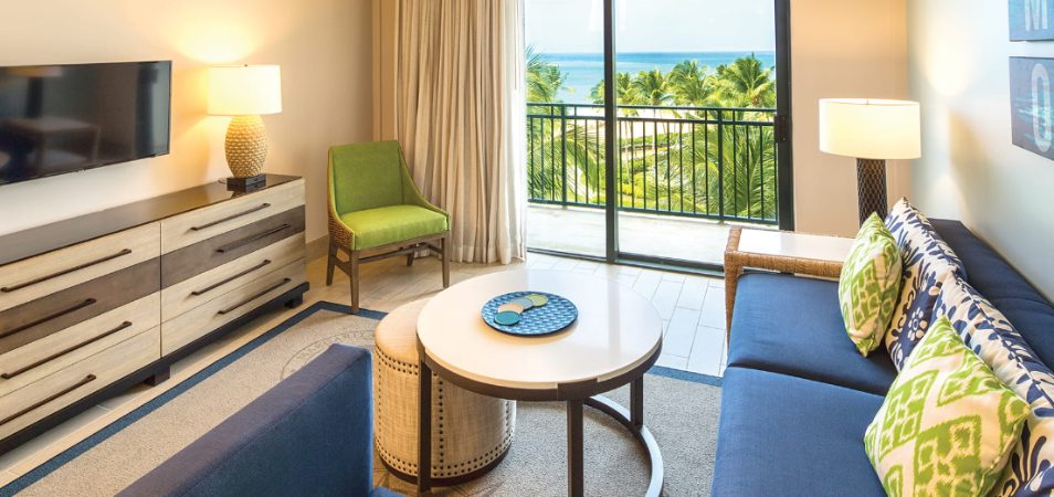 Suite living room with a sliding door to an oceanview balcony at Margaritaville Vacation Club by Wyndham - Rio Mar.