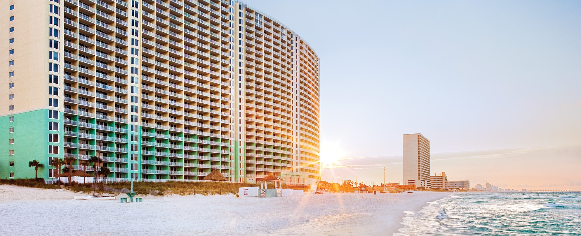 The exterior Club Wyndham Panama City Beach, an oceanfront timeshare resort in Panama City Beach, Florida at sunset.