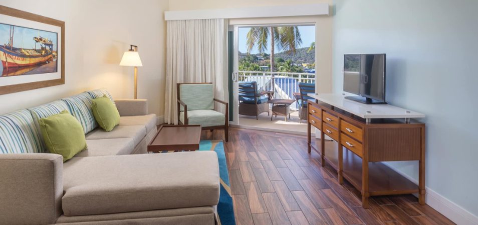 Couch and tv in the living room of a suite at Margaritaville Vacation Club by Wyndham - St. Thomas.