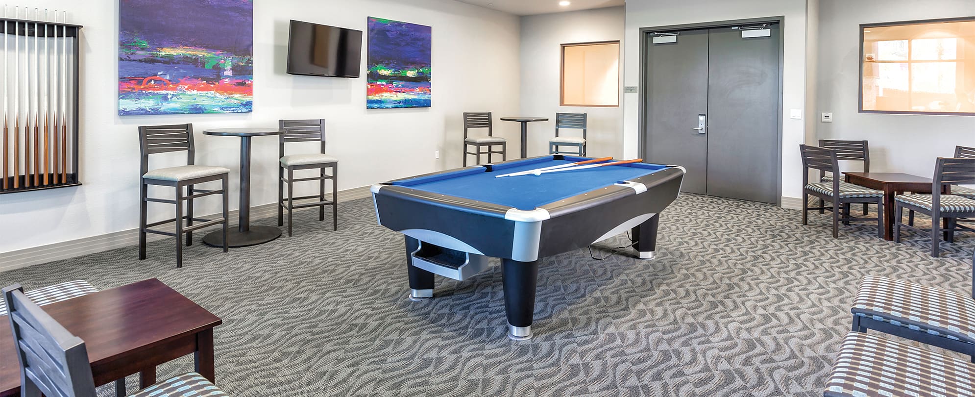 Room with a pool table, TV, and chairs at Margaritaville Vacation Club by Wyndham - Desert Blue in Las Vegas, NV.