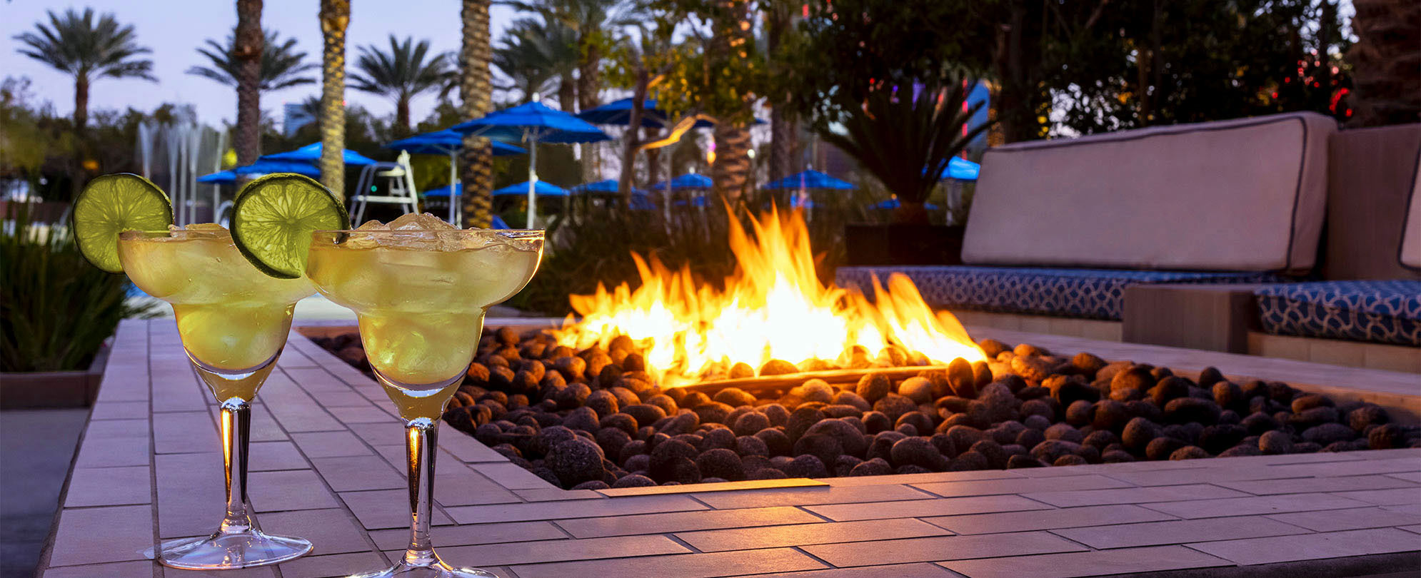 Cocktails around the fire pit and pool at Margaritaville Vacation Club by Wyndham - Desert Blue in Las Vegas, NV.