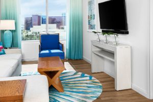 A bright and colorful bedroom and living room at Margaritaville Vacation Club by Wyndham - Desert Blue in Las Vegas, NV.